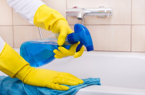 Domestic cleaner tidying a kitchen in Chiswick