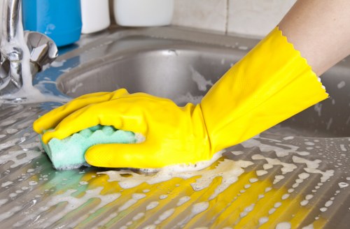 Team member handling cleaning chemicals safely with proper labeling